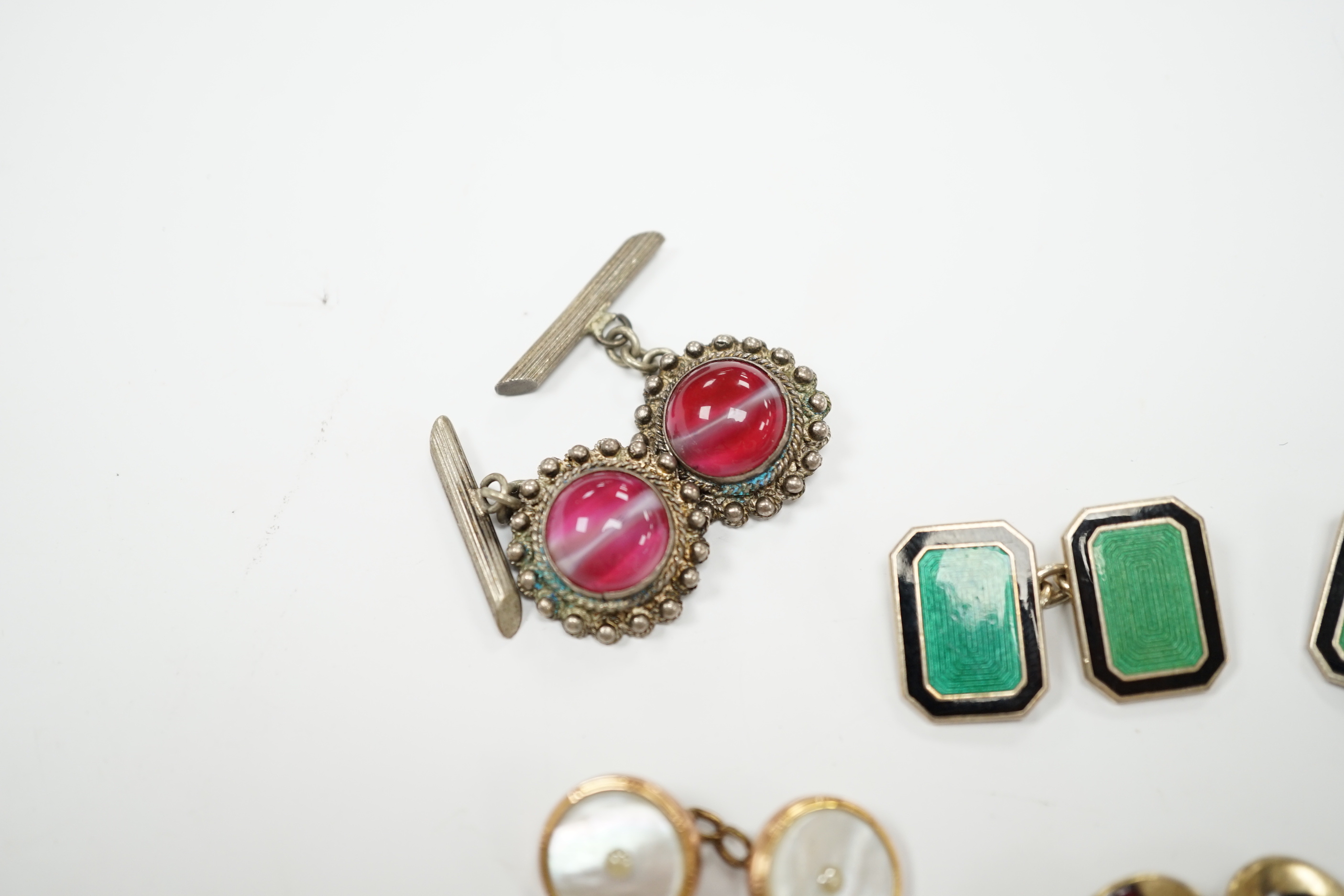 Four assorted pairs of cufflinks including silver and two coloured enamel.